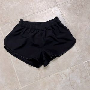 Black Lululemon shorts with small holes, unlined. Size 4.